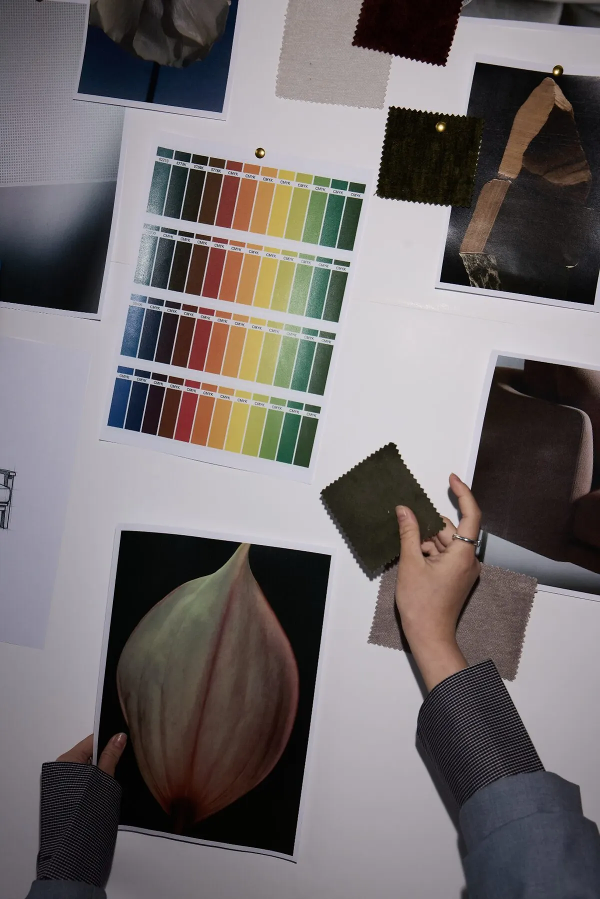 Hands placing swatches into an order, close in.