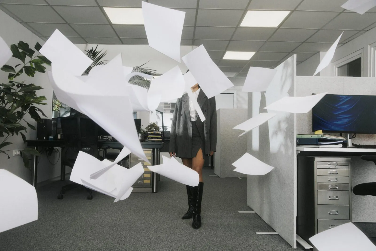 Office paper caught in mid-air, a wide frame.