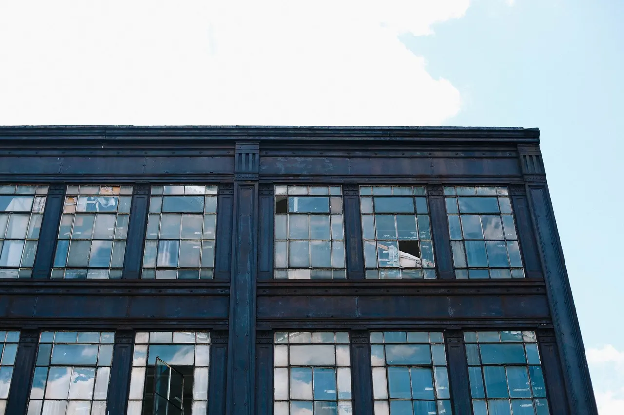 An institutional blue glass facade filling a wide frame.