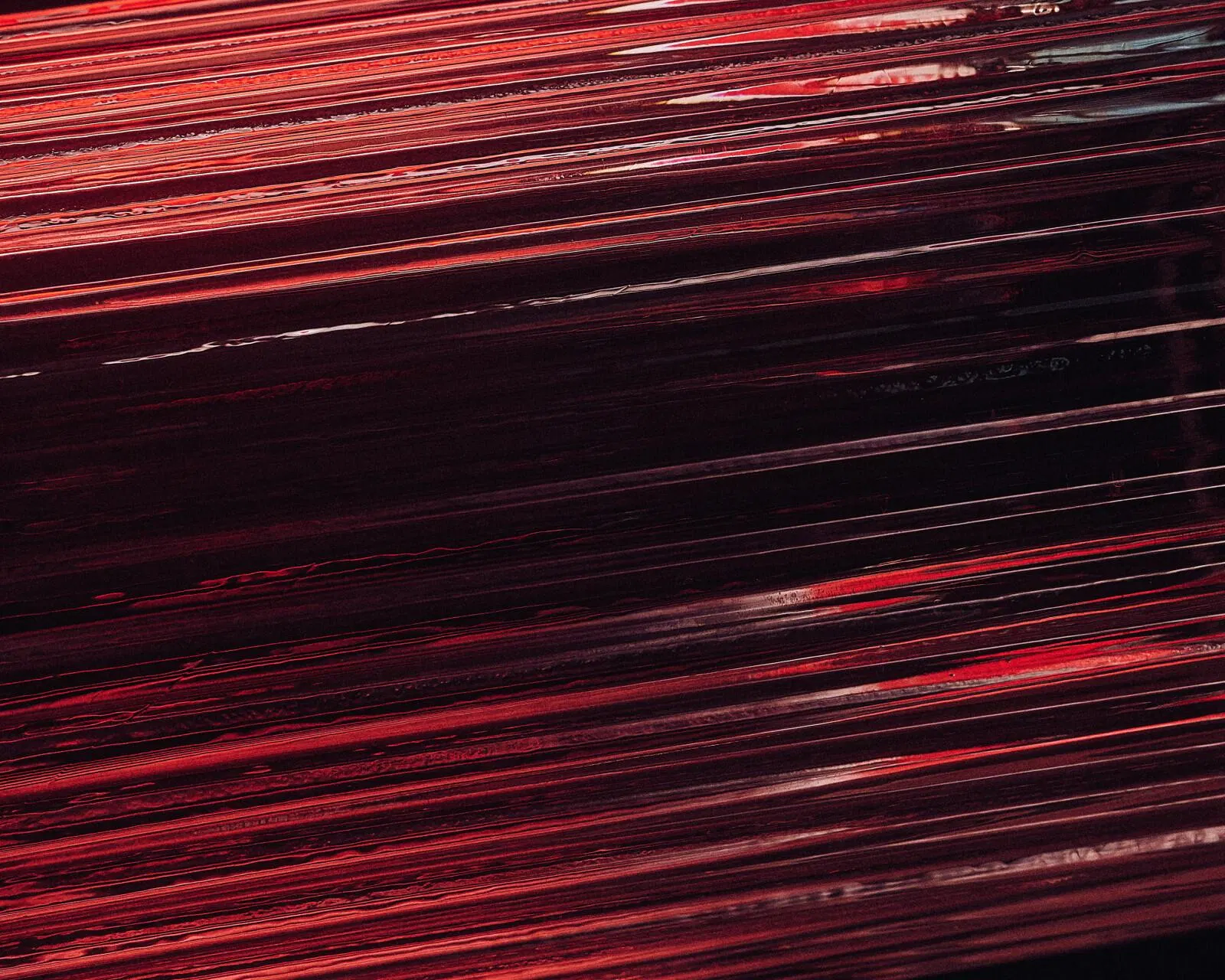 An abstract red streak of light across black — velocity.